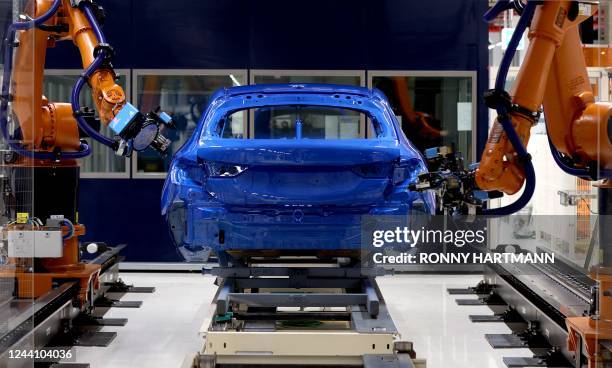 Robots measure the thickness of paint on a car body at Germany's carmaker BMW plant in Leipzig, eastern Germany, on October 20, 2022. - Eight new...