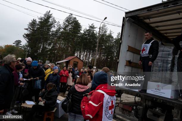 Ukrainian civilians queue for humanitarian aid provided by the Red Cross as people try to survive amid the wave of Russia's missile strikes in...