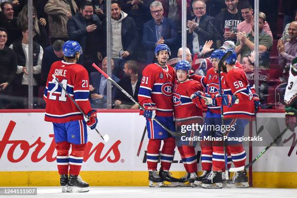 Cole Caufield of the Montreal Canadiens celebrates his goal with teammates Kaiden Guhle, Sean Monahan, Nick Suzuki and David Savard during the first...