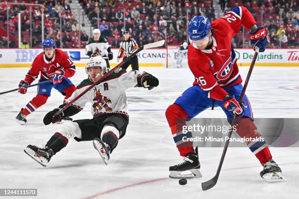 Clayton Keller of the Arizona Coyotes falls as Johnathan Kovacevic of the Montreal Canadiens skates the puck ahead of him during the first period at...