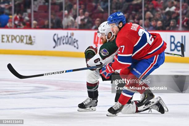 Lawson Crouse of the Arizona Coyotes and Jonathan Drouin of the Montreal Canadiens skate against each other during the first period at Centre Bell on...