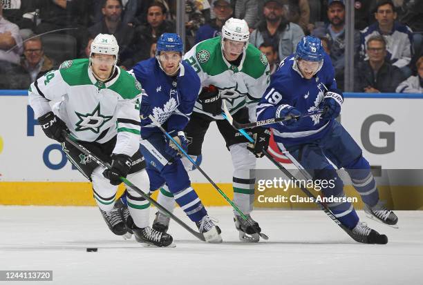 Denis Gurianov of the Dallas Stars skates with the puck against Alexander Kerfoot and Calle Jarnkrok of the Toronto Maple Leafs during the second...