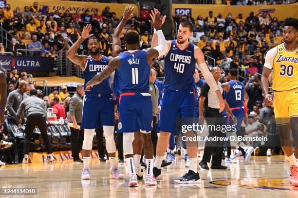 John Wall high fives Ivica Zubac of the LA Clippers during the game against the Los Angeles Lakers on October 20, 2022 at Crypto.com Arena in Los...