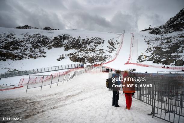 People stand in front of a slope as the inspection is canceled due to strong wind and bad weather conditions ahead of the FIS Ski Alpine Worldcup in...