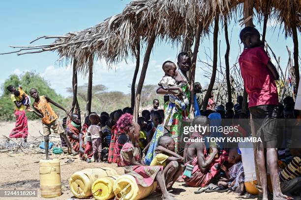 Women from the pastoral Turkana community wait on October 18, 2022 under a makeshift shed with their children at a drought-intervention community...