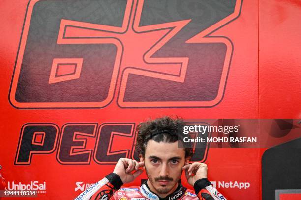 Ducati Lenovo Team's Italian rider Francesco Bagnaia adjusts his earpiece during the second MotoGP free practice at the Sepang International Circuit...