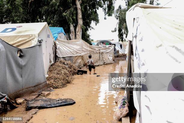 Syrian refugee child is seen as mud covers the refugee camp after heavy rain caused flood damaging their camp in Idlib, Syria on October 21, 2022.