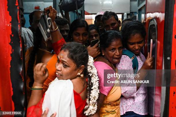 Passengers board a crowded train to visit their respective hometown ahead of the Hindu festival of Diwali, in Chennai on October 21, 2022.
