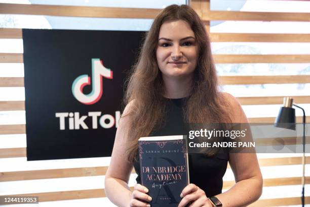 German Author Sarah Sprinz poses for a picture with her book at the TikTok Stands during the 23rd Frankfurt Book Fair at the Messe in Frankfurt am...
