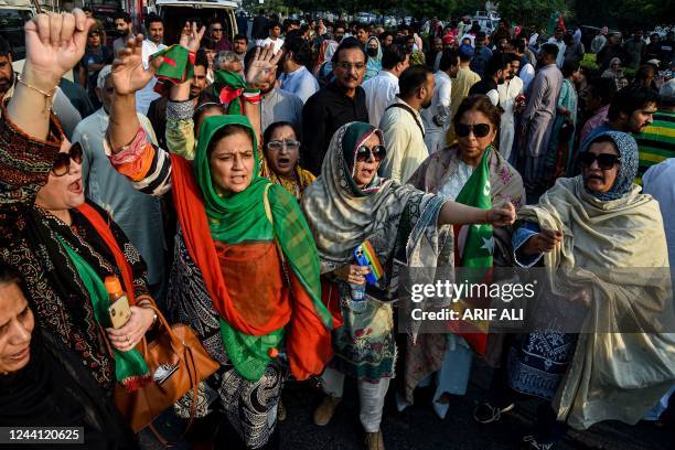 Women activists of Pakistan Tehreek-e-Insaf party shout slogans against the disqualifying decision of former prime minister Imran Khan on a street in...