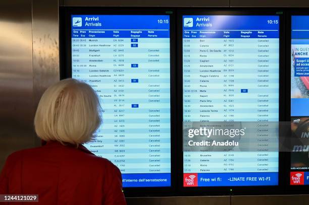 Passenger looks at information screens at Milan Linate Airport in Milan, Italy on October 21, 2022 as union called a 24h general strike of the...