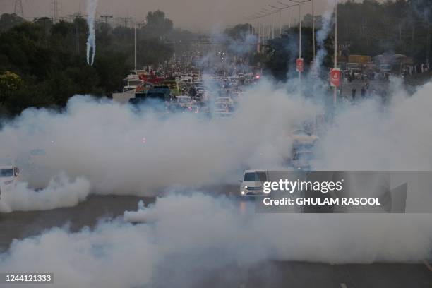 Police use teargas to disperse protestors of Pakistan Tehreek-e-Insaf during a demonstration against the decision to disqualify former prime minister...