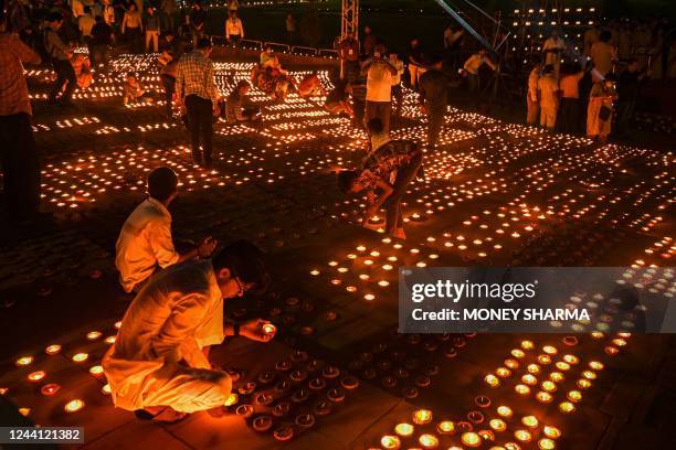 Volunteers light earthen lamps in Diye Jalao, Patake Nahi campaign launched in Delhi to raise awareness to masses to celebrate Dipawali with Diyas...