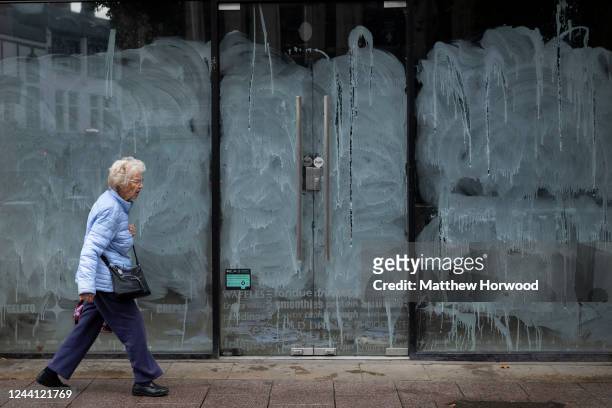 Woman walks past a closed retail store on October 21, 2022 in Cardiff, United Kingdom. The Office For National Statistics announced that September's...