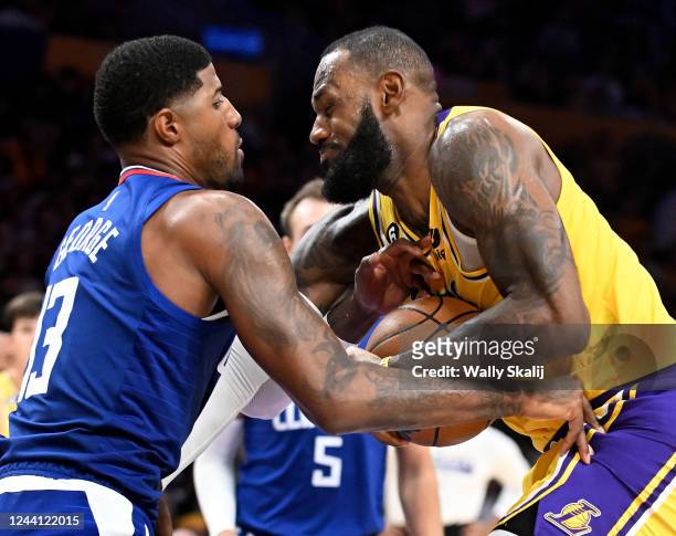 Los Angeles, California October 20, 2022-Lakers LeBron James gets fouled by Clippers Paul George in the fourth quarter at Crypto Arena in Los Angeles...