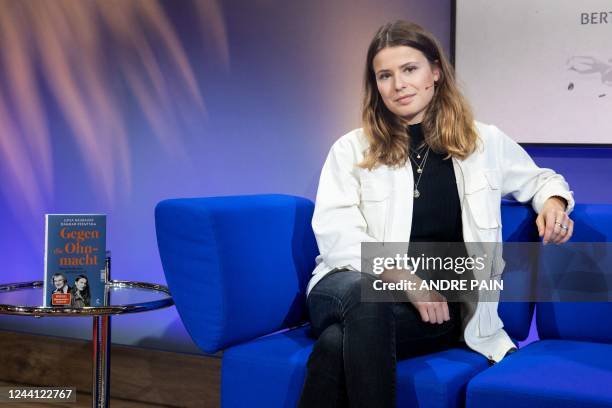 German climate activist and author Luisa Neubauer poses next to her book during an interview on the Blue Sofa during the 23rd Frankfurt Book Fair at...