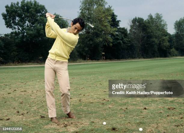 Tottenham Hotspur and Argentina footballer Osvaldo Ardiles practising his swing during a golf lesson, circa 1981.