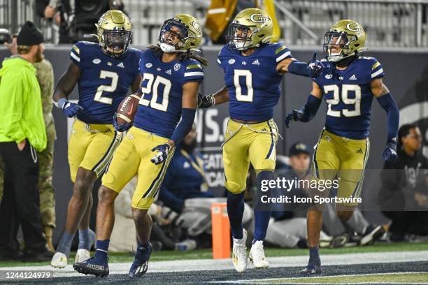 Georgia Tech defensive back LaMiles Brooks celebrates with teammates after returning an interception for a touchdown during the college football game...