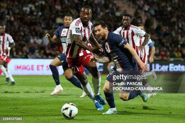Paris Saint-Germain's Argentine forward Lionel Messi fights for the ball with Ajaccio's French defender Cedric Avinel during the French L1 football...