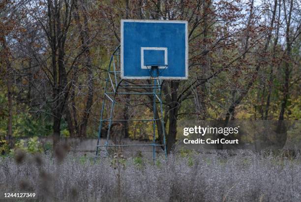 Weeds and grass grow around a disused basketball hoop on October 21, 2022 in Kostyantynivka, Donetsk oblast, Ukraine. Ukrainian president Volodymyr...