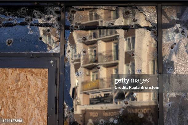 Bullet holes are seen on the McDonalds building as the war torn city comes back to life after many residents returned and shops reopened on October...