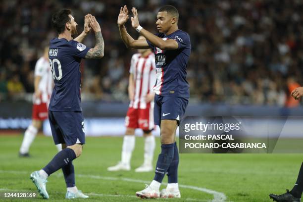 Paris Saint-Germain's French forward Kylian Mbappe is congratulated by Paris Saint-Germain's Argentine forward Lionel Messi after scoring a goal...