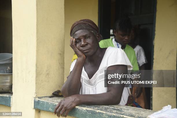 Woman looks on in an internally displaced people's camp, where flood evacuees are accommodated, at Community Primary School in Ihuike, Niger delta...