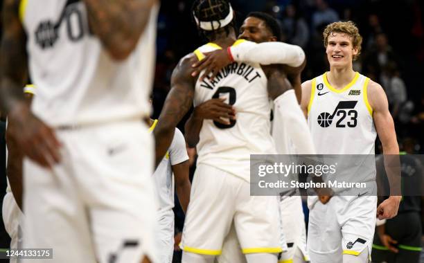 Lauri Markkanen of the Utah Jazz looks on as Jarred Vanderbilt and Malik Beasley celebrate after the game against the Minnesota Timberwolves at...