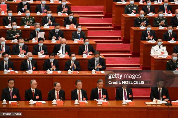 China's President Xi Jinping attends the closing ceremony of the 20th Chinese Communist Party's Congress with former chairman of the Standing...