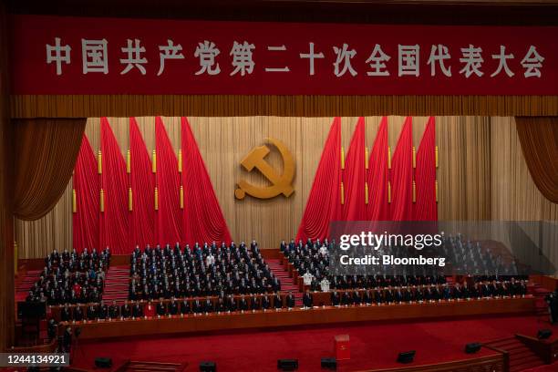 Delegates stand during the closing session of the 20th National Congress of the Chinese Communist Party at the Great Hall of the People in Beijing,...