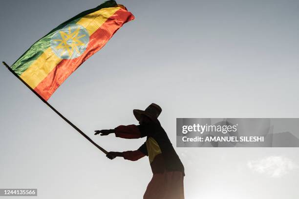 Man waves an Ethiopian flag as he join others gathering in Addis Ababa, Ethiopia, on October 22, 2022 during a demonstration in support of Ethiopia...