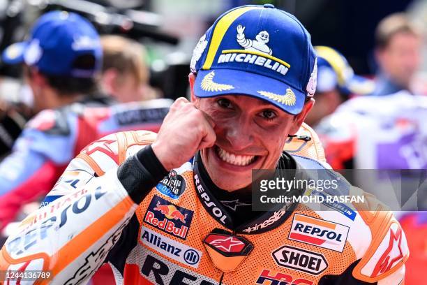 Repsol Honda's Spanish rider Marc Marquez poses after finishing third in the second MotoGP qualifying session at the Sepang International Circuit in...