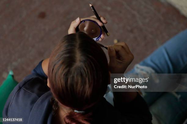 Venezuelan migrant woman puts on makeup during her reception at a shelter in Mexico City.