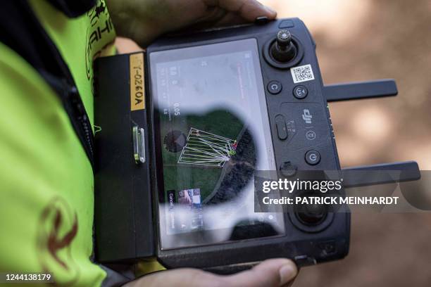 Kenya Airways employee controls an unmanned aerial vehicle as it spreads fertilizer over a tea farm at Kipkebe Tea Estate in Musereita on October 21,...