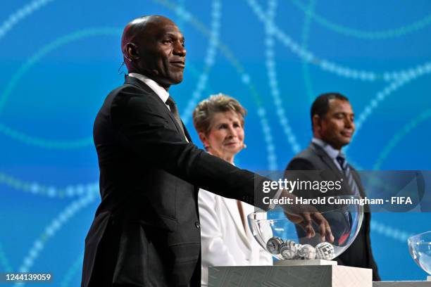 Draw Assistant Geremi Njitap shuffles the balls during the FIFA Women's World Cup 2023 Final Draw at the Aotea Centre on October 22, 2022 in...