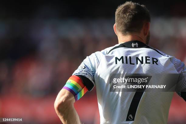 Liverpool's English midfielder and captain James Milner wears a rainbow coloured armband during the English Premier League football match between...