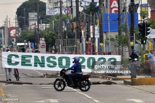 Motorcyclist rides through a blocked street during an indefinite strike called by trade unions opposed to the government of Bolivian President Luis...