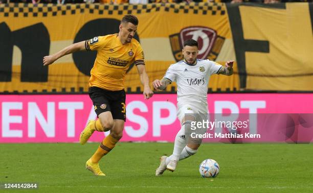 Stefan Kutschke of Dresden challenges for the ball with Calogero Rizzuto of Saarbruecken during the 3. Liga match between Dynamo Dresden and 1. FC...