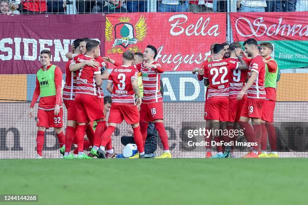 Ermedin Demirovic of FC Augsburg celebrates after scoring his team's second goal with teammates during the Bundesliga match between FC Augsburg and...