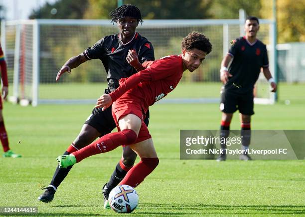 Ranel Young of Liverpool and Zane Rattray of Stoke City in action at AXA Training Centre on October 21, 2022 in Kirkby, England.