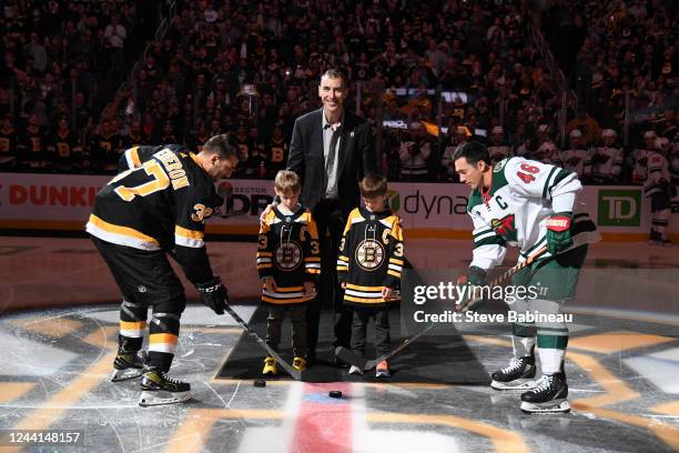 Zdeno Chara and his sons Zack and Ben drop the puck and pose for a photo with Patrice Bergeron of the Boston Bruins and Jared Spurgeon of the...