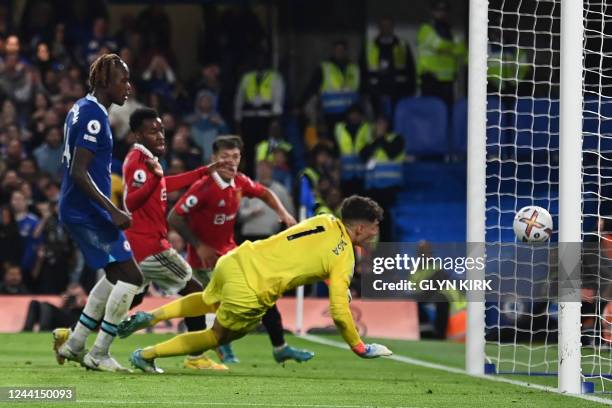 Chelsea's Spanish goalkeeper Kepa Arrizabalaga fails to keep the ball from crossing his line from a header by Manchester United's Brazilian...