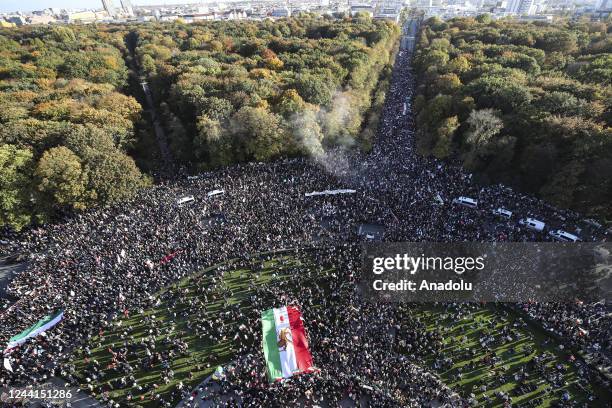 An aerial view shows people gathering in front of the Victory Column and holding banners and flags during a solidarity march for Iranian protests...