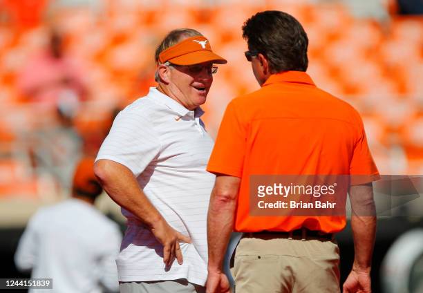 Head coach Mike Gundy of the Oklahoma State Cowboys talks with Gary Patterson, special assistant to the head coach of the Texas Longhornsm before...