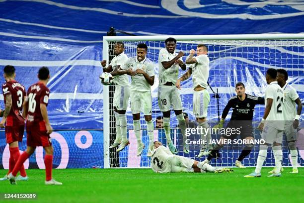 Real Madrid's players jump for the ball as Sevilla's Croatian midfielder Ivan Rakitic takes a free-kick during the Spanish league football match...