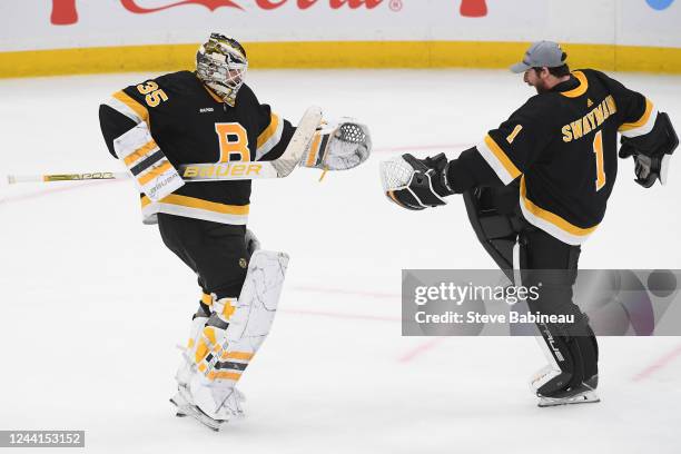 Linus Ullmark and Jeremy Swayman of the Boston Bruins celebrate the overtime win against the Minnesota Wild at the TD Garden on October 22, 2022 in...