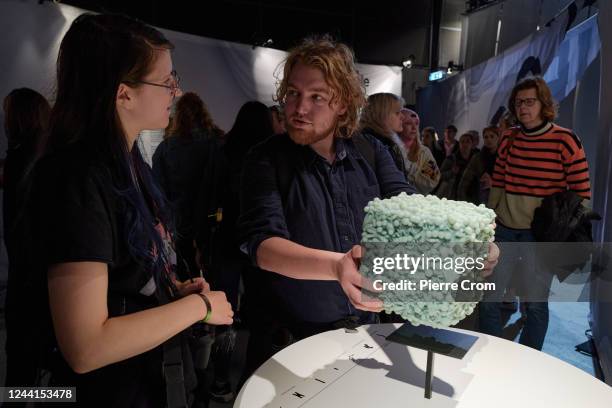 People lift a cube representing the weight of gut microbiome in human bodies during the Dutch Design Week on October 22, 2022 in Eindhoven,...