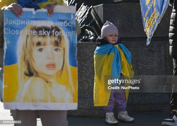 Young girl holding a Ukrainian national flag cries during the protest. Ukrainians people living in Krakow and their supporters protesting in Krakow's...