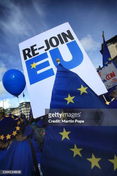 An EU supporters holds up a sign saying 'Re-Join EU' on October 22, 2022 in London, United Kingdom. Protesters implore the government to make EU...