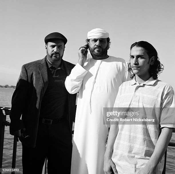 Arab-American men pose for a photograph in a public park during the Muslim Eid al-Fitr prayers and celebrations at the end of Ramadan August 30, 2011...